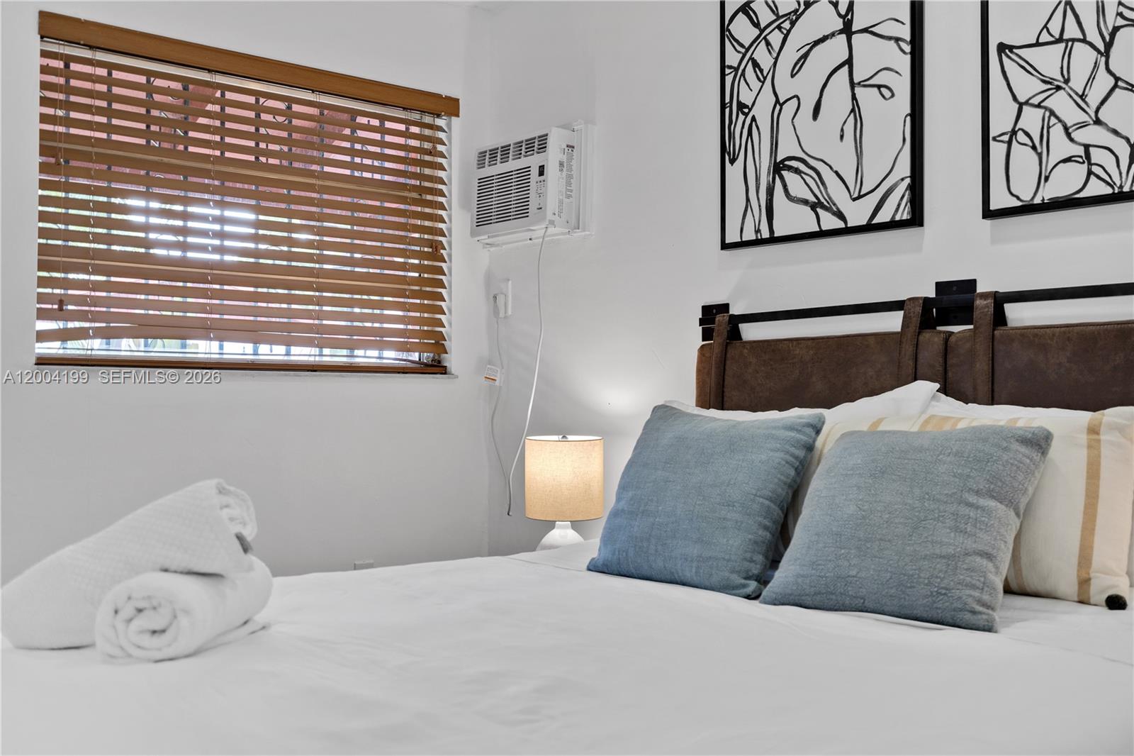 1841 Southwest 29th Avenue, Unit B Miami, FL 33145 - Photo 17 of 24 a bedroom with a large bed and a window