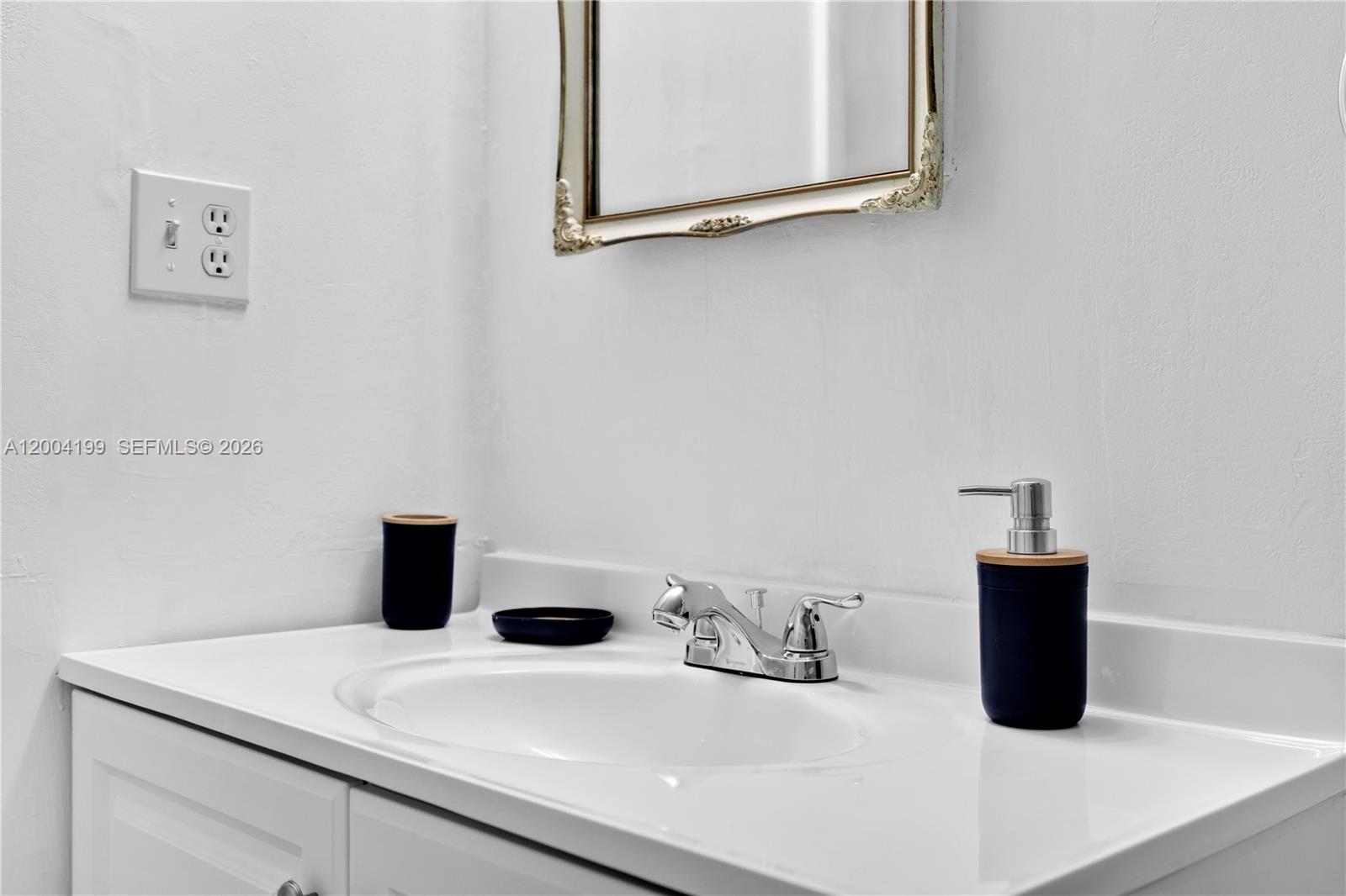 1841 Southwest 29th Avenue, Unit B Miami, FL 33145 - Photo 21 of 24 a bathroom with a sink and a mirror