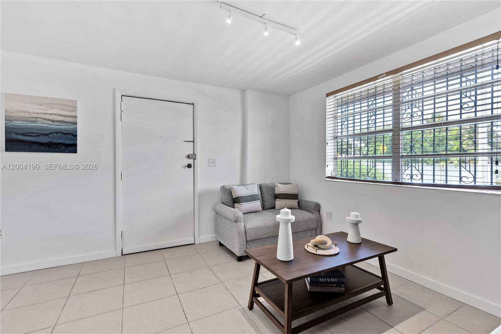 1841 Southwest 29th Avenue, Unit B Miami, FL 33145 - Photo 6 of 24 a living room with furniture and a flat screen tv
