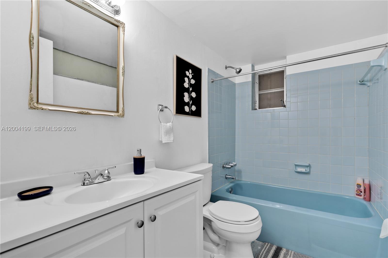 1841 Southwest 29th Avenue, Unit B Miami, FL 33145 - Photo 10 of 24 a bathroom with a sink and a mirror