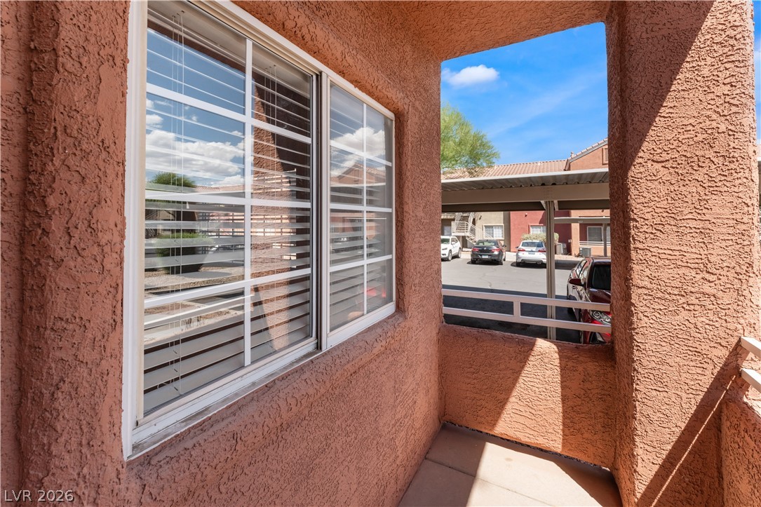 4730 East Craig Road, Unit 1058 Las Vegas, NV 89115 - Photo 28 of 30 A private balcony offers a peaceful retreat with a view of the covered parking area.