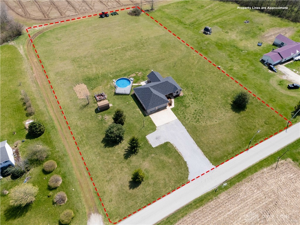 5264 Frazier-Guy Road Sidney, OH 45365 - Photo 6 of 51 An aerial view showcases a residential property with extensive green space and outdoor amenities.