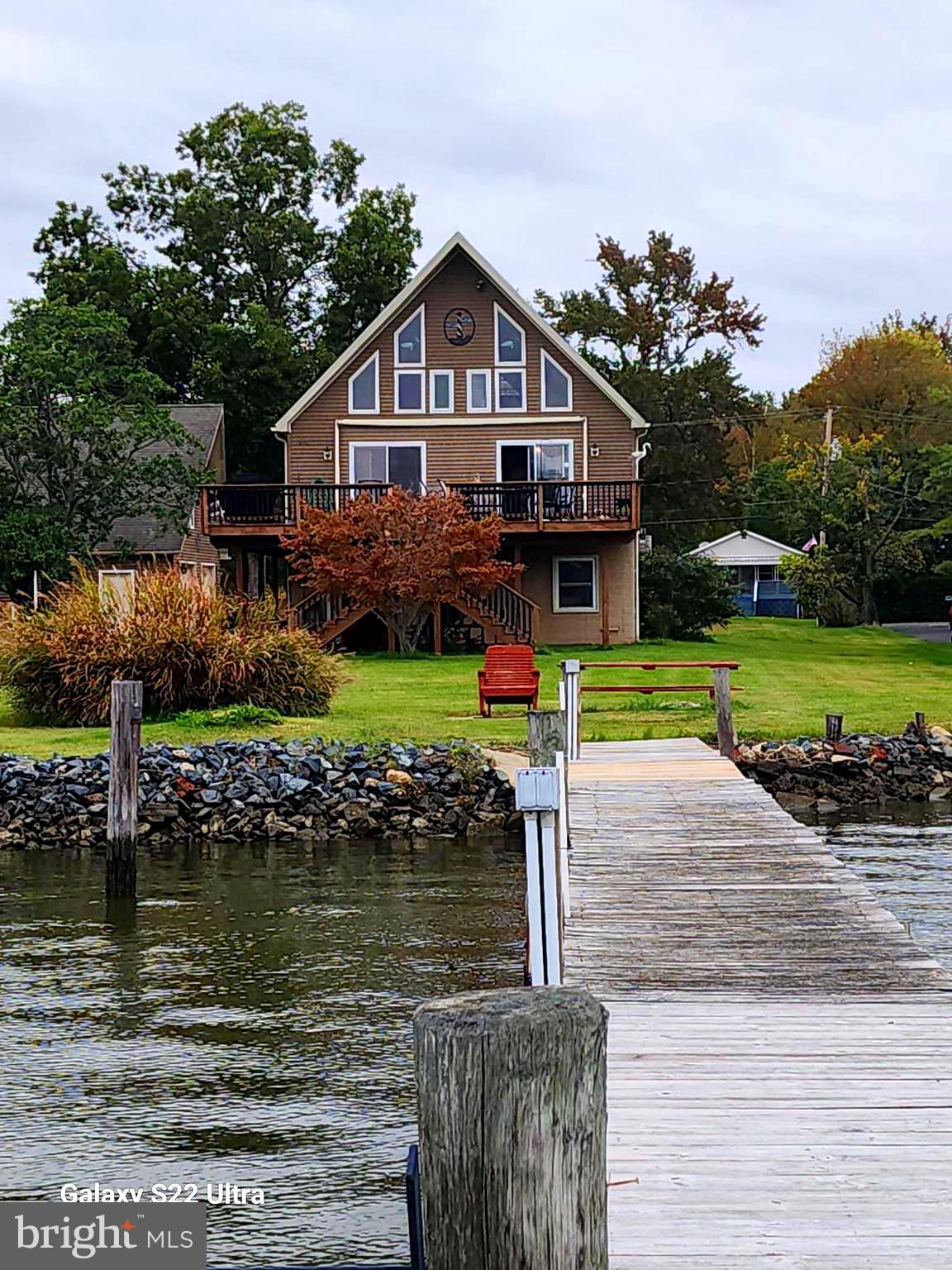 a front view of a house with a yard table and chairs
