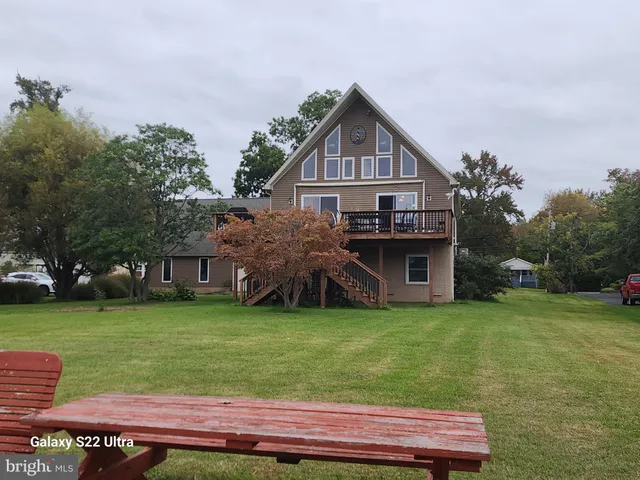a view of a house with a yard porch and sitting area