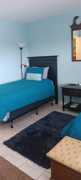 10145 Sunrise Lakes Boulevard, Unit 405 Sunrise, FL 33322 - Photo 13 of 48 a bedroom with a bed and a night stand