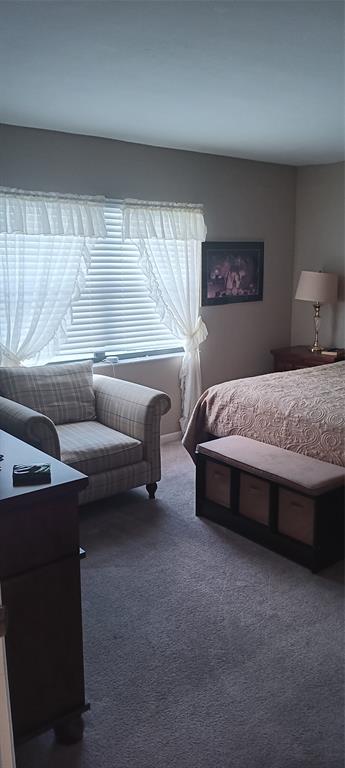 10145 Sunrise Lakes Boulevard, Unit 405 Sunrise, FL 33322 - Photo 25 of 48 a spacious bedroom with a bed and a couch