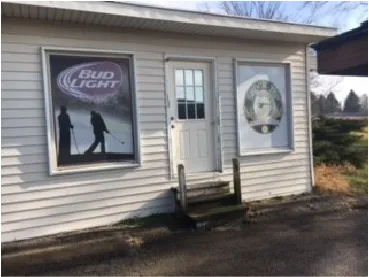 a dining hall with stainless steel appliances kitchen island granite countertop a table chairs in it and a window