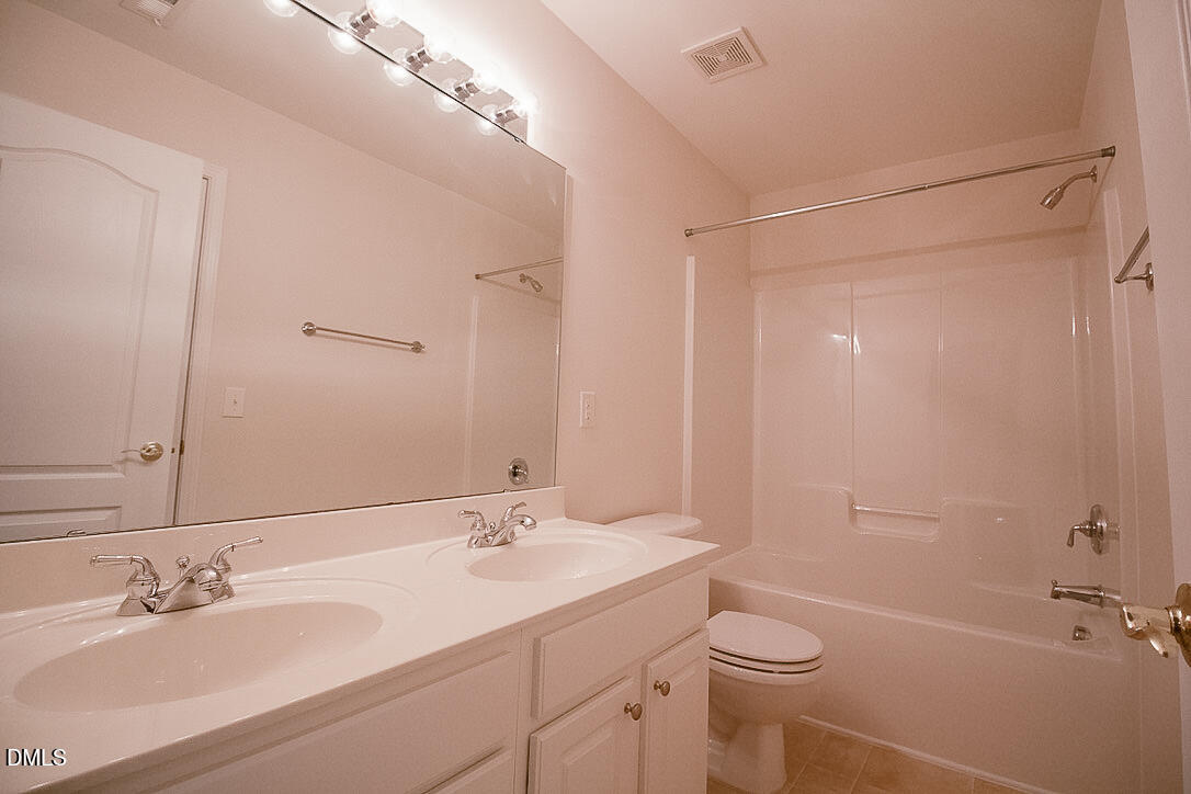 5335 Brandy Bay Road Raleigh, NC 27613 - Photo 20 of 29 a bathroom with a sink toilet double vanity and shower