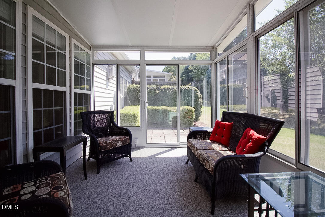 5335 Brandy Bay Road Raleigh, NC 27613 - Photo 24 of 29 a living room with furniture and a floor to ceiling window