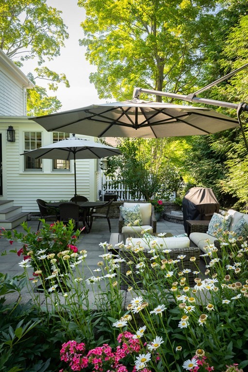 10 Elm Street Hingham, MA 02043 - Photo 18 of 19 a backyard of a house with a yard and outdoor seating