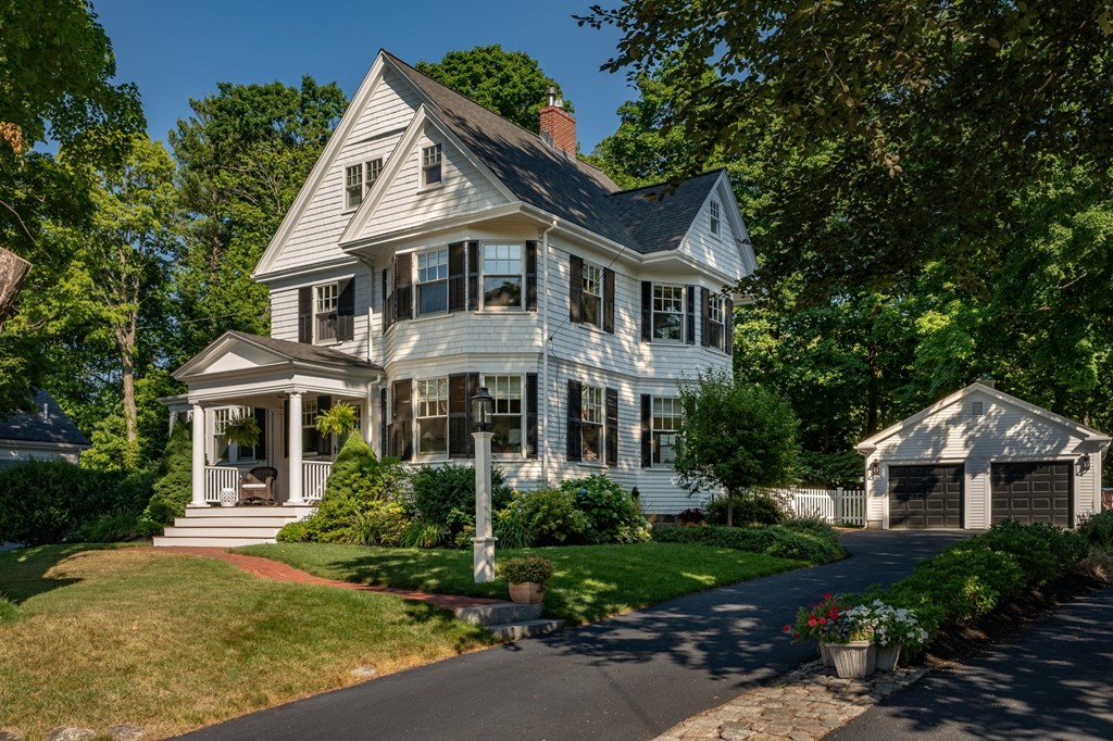 10 Elm Street Hingham, MA 02043 - Photo 2 of 19 a front view of a house with a yard and garage