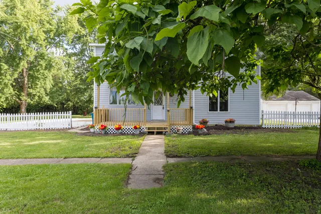 a backyard of a house with table and chairs