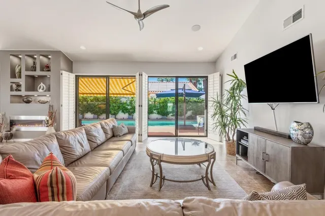 a kitchen with stainless steel appliances kitchen island granite countertop a table and chairs in it