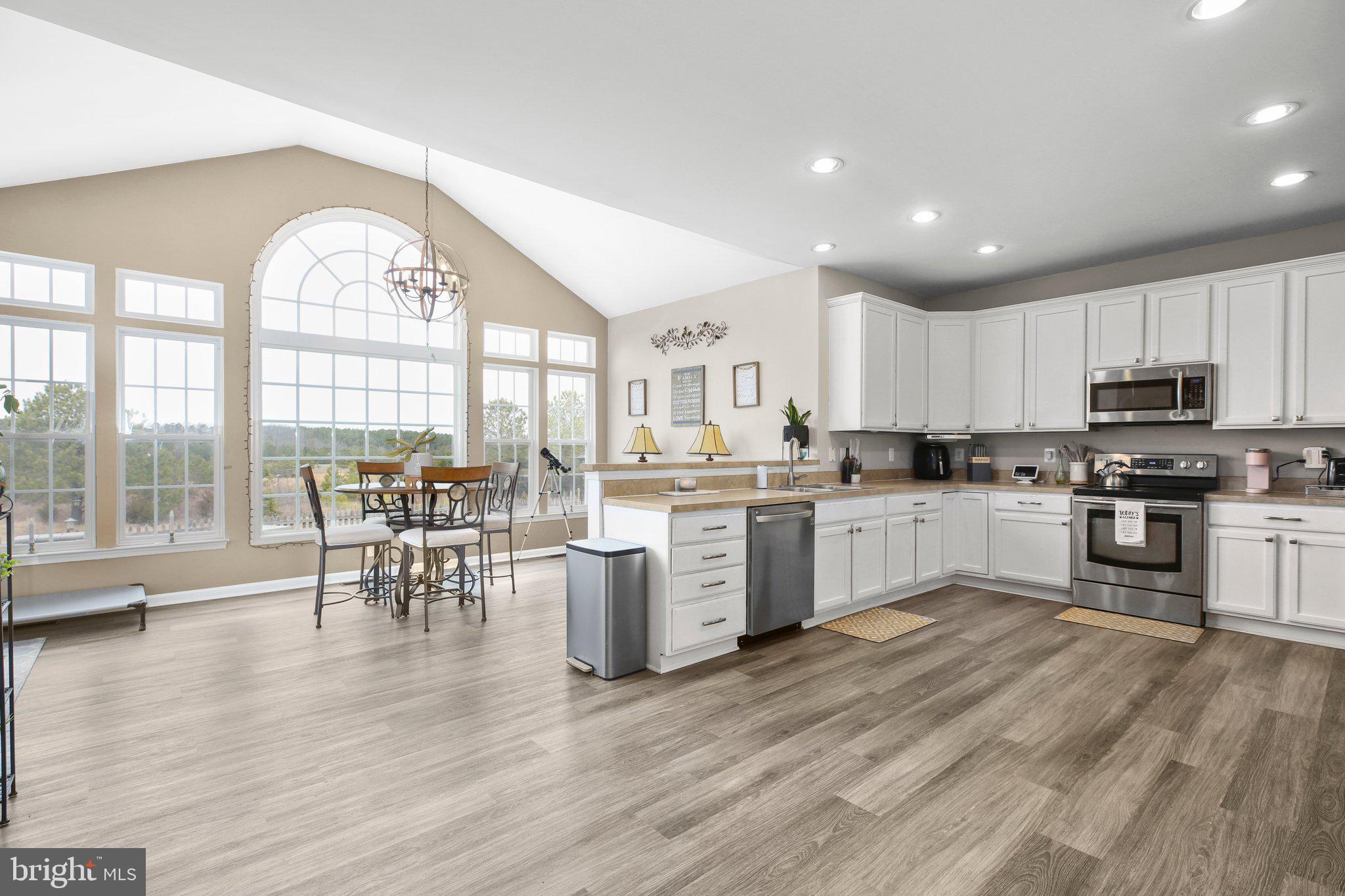 a kitchen with a white cabinets and chairs