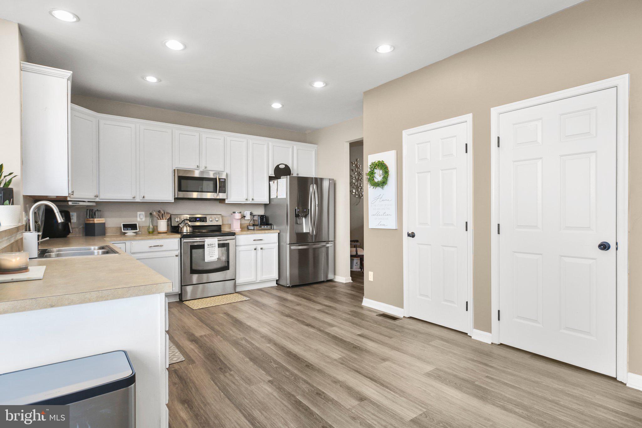 5233 Windbreak Drive Fredericksburg, VA 22407 - Photo 17 of 53 a kitchen with white cabinets and stainless steel appliances