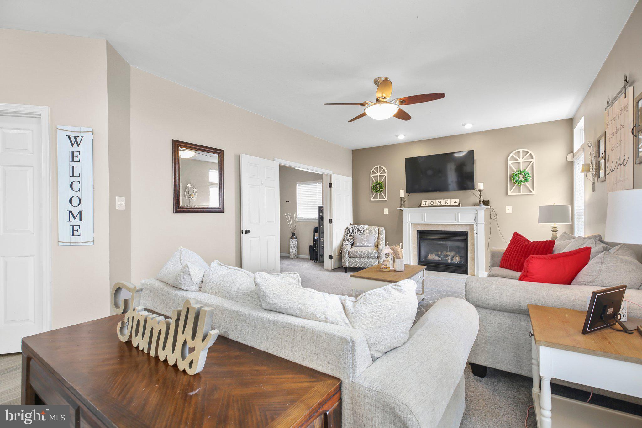 5233 Windbreak Drive Fredericksburg, VA 22407 - Photo 20 of 53 a living room with furniture fireplace and a flat screen tv