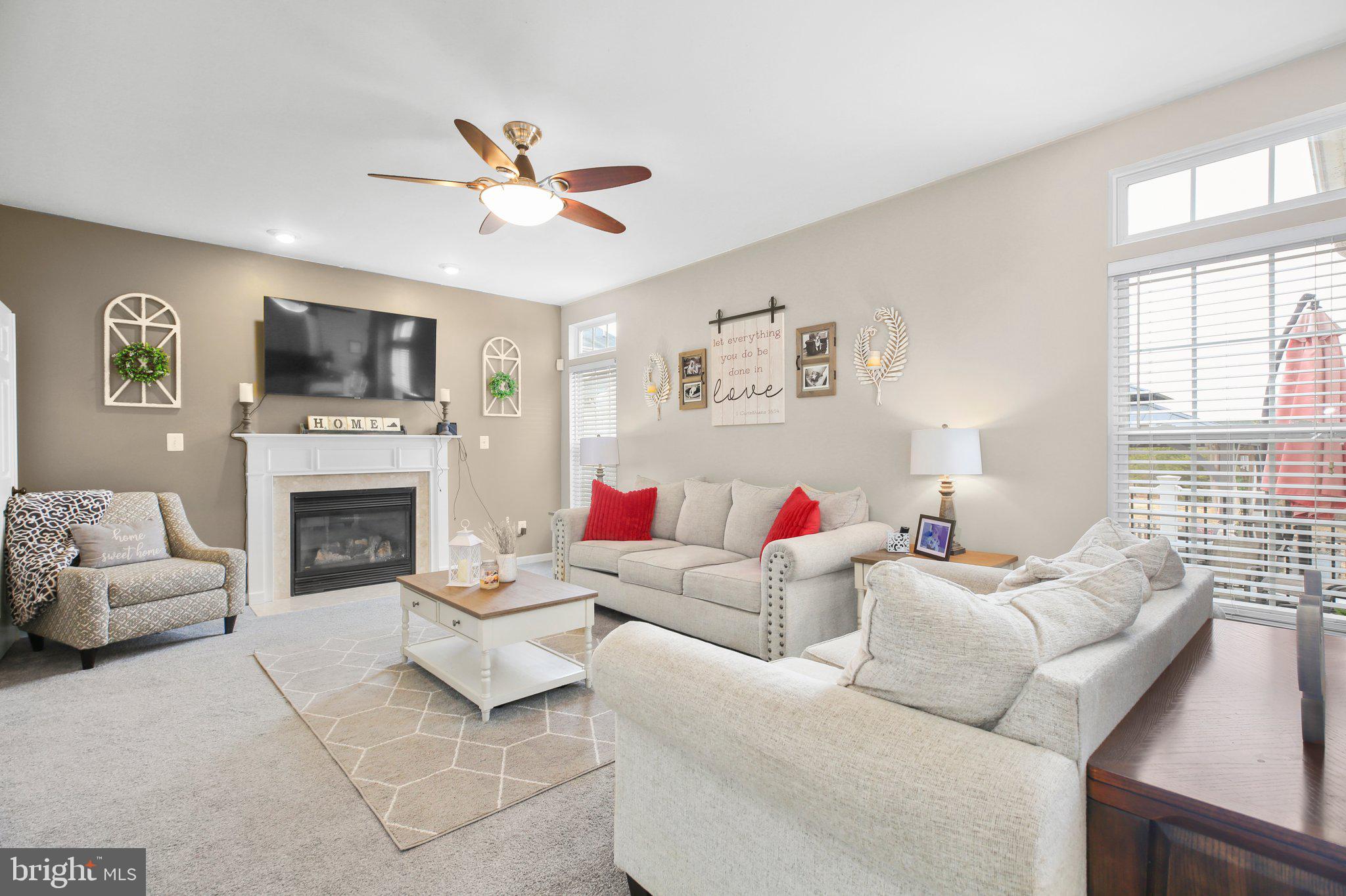 5233 Windbreak Drive Fredericksburg, VA 22407 - Photo 21 of 53 a living room with furniture a fireplace and a flat screen tv