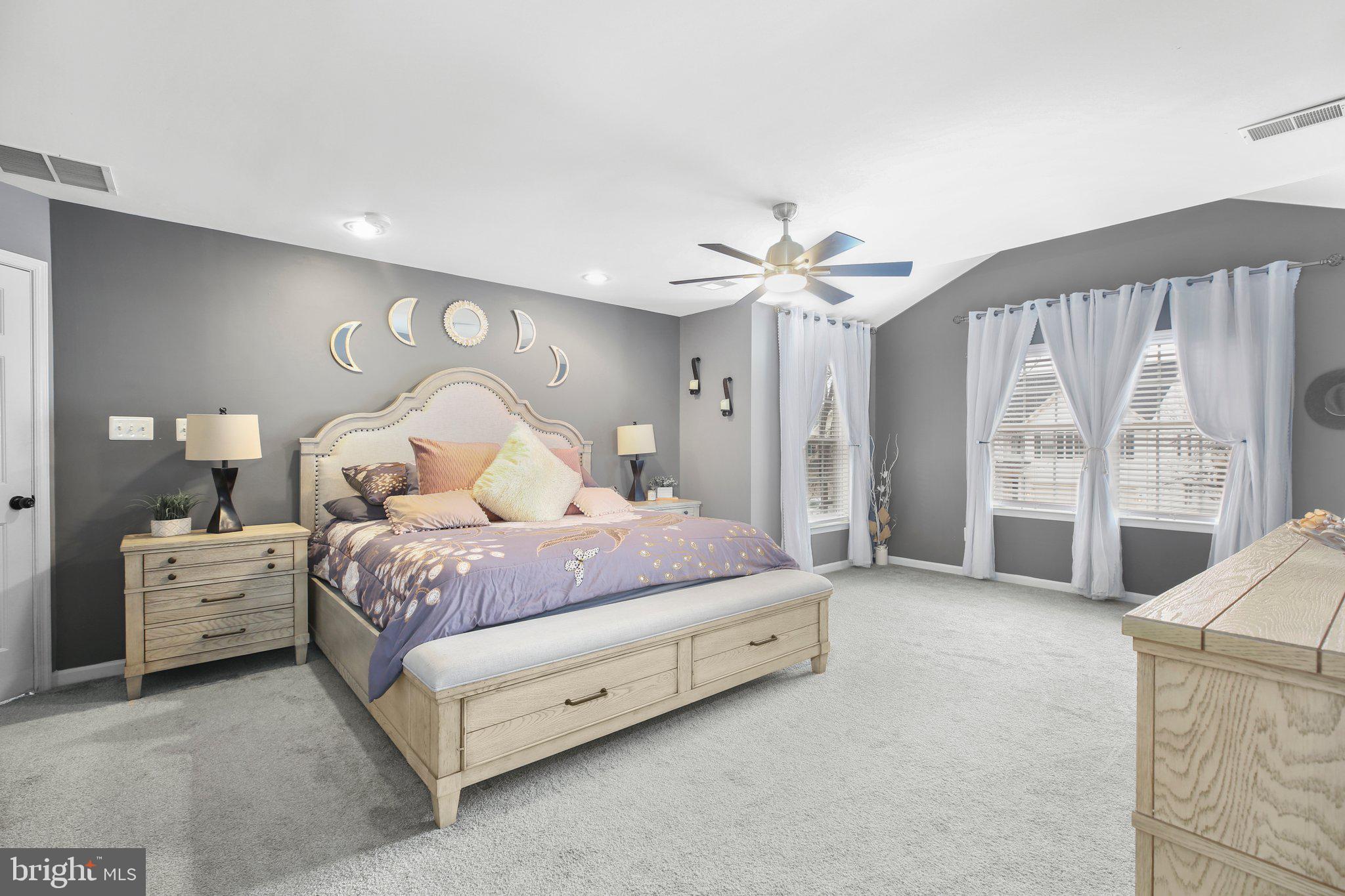 5233 Windbreak Drive Fredericksburg, VA 22407 - Photo 27 of 53 a spacious bedroom with a bed a chandelier and large window
