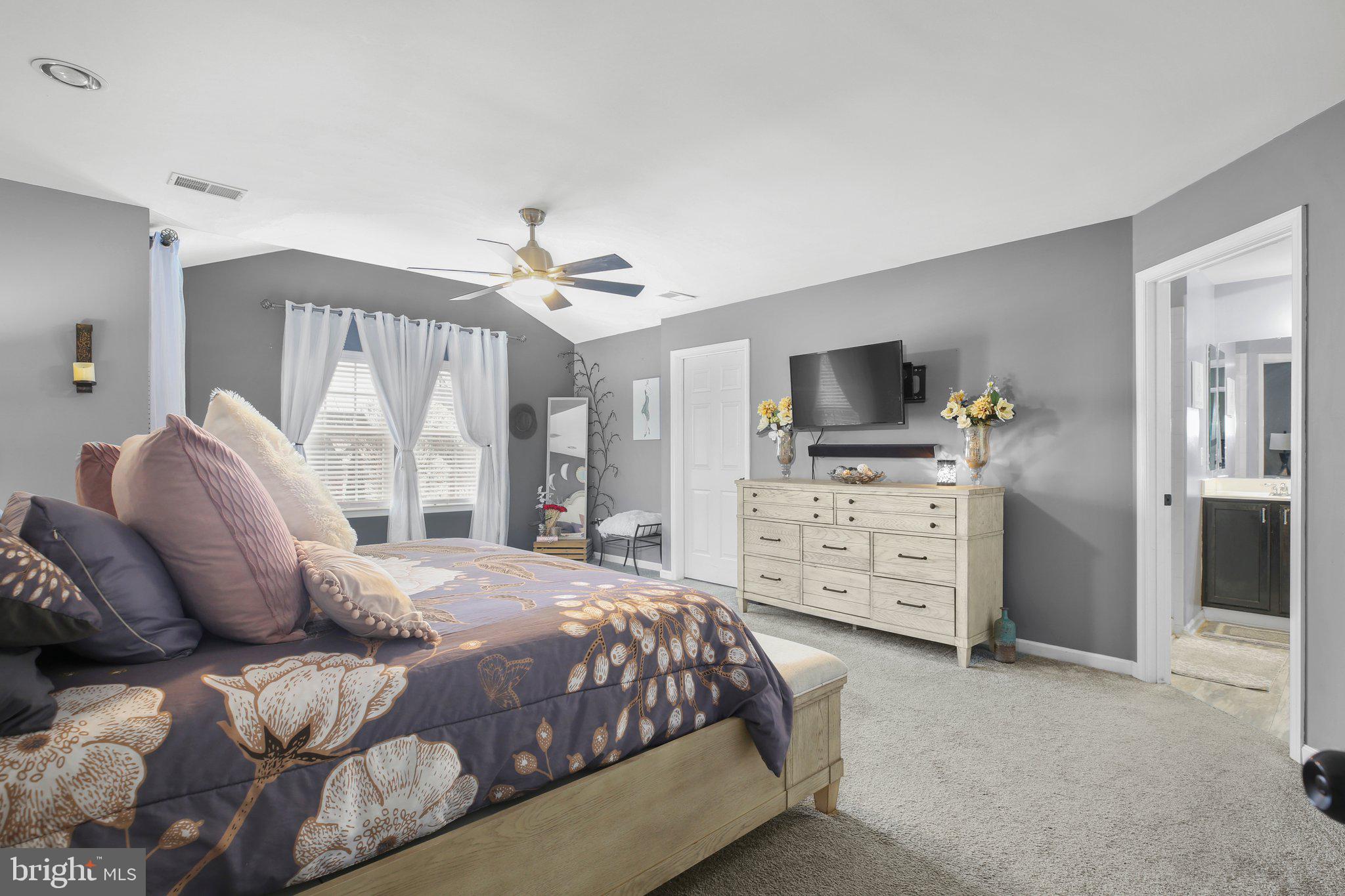 5233 Windbreak Drive Fredericksburg, VA 22407 - Photo 28 of 53 a spacious bedroom with a bed and a flat screen tv