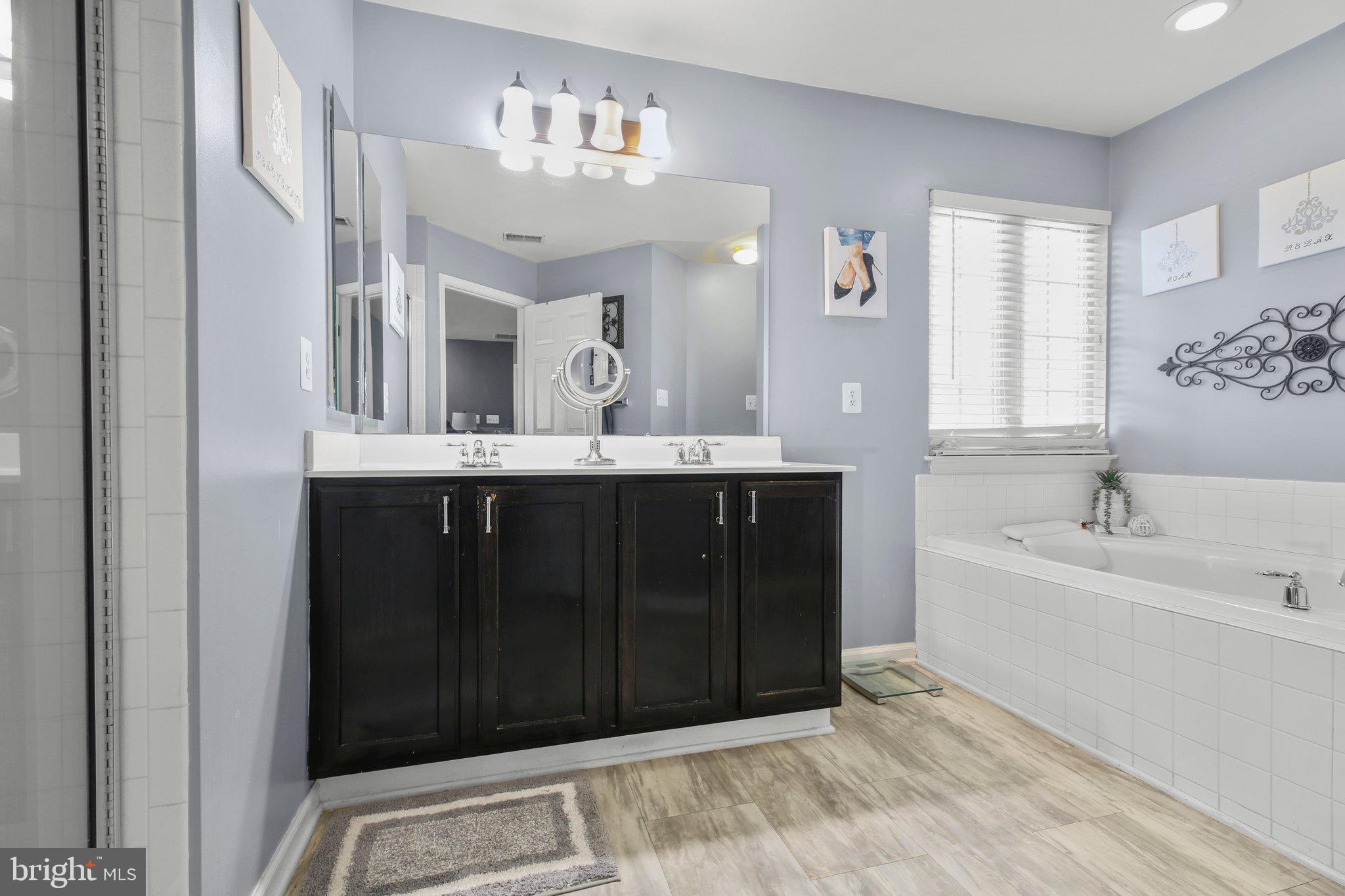 5233 Windbreak Drive Fredericksburg, VA 22407 - Photo 32 of 53 a spacious bathroom with a bathtub sink and mirror