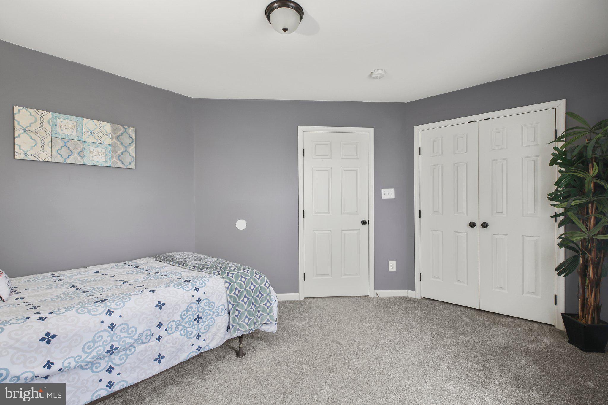 5233 Windbreak Drive Fredericksburg, VA 22407 - Photo 37 of 53 a bedroom with a bed and a potted plant