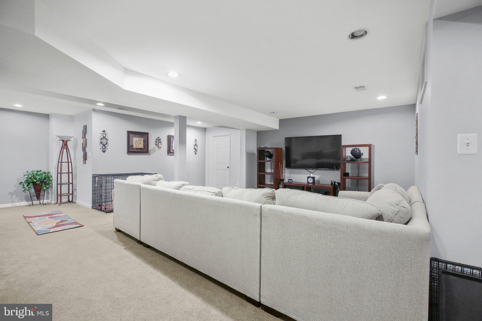5233 Windbreak Drive Fredericksburg, VA 22407 - Photo 43 of 53 a living room with furniture and a flat screen tv