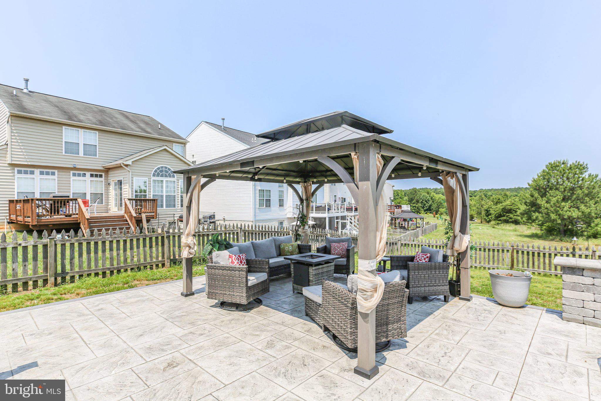 5233 Windbreak Drive Fredericksburg, VA 22407 - Photo 52 of 53 a view of a patio with a table and chairs