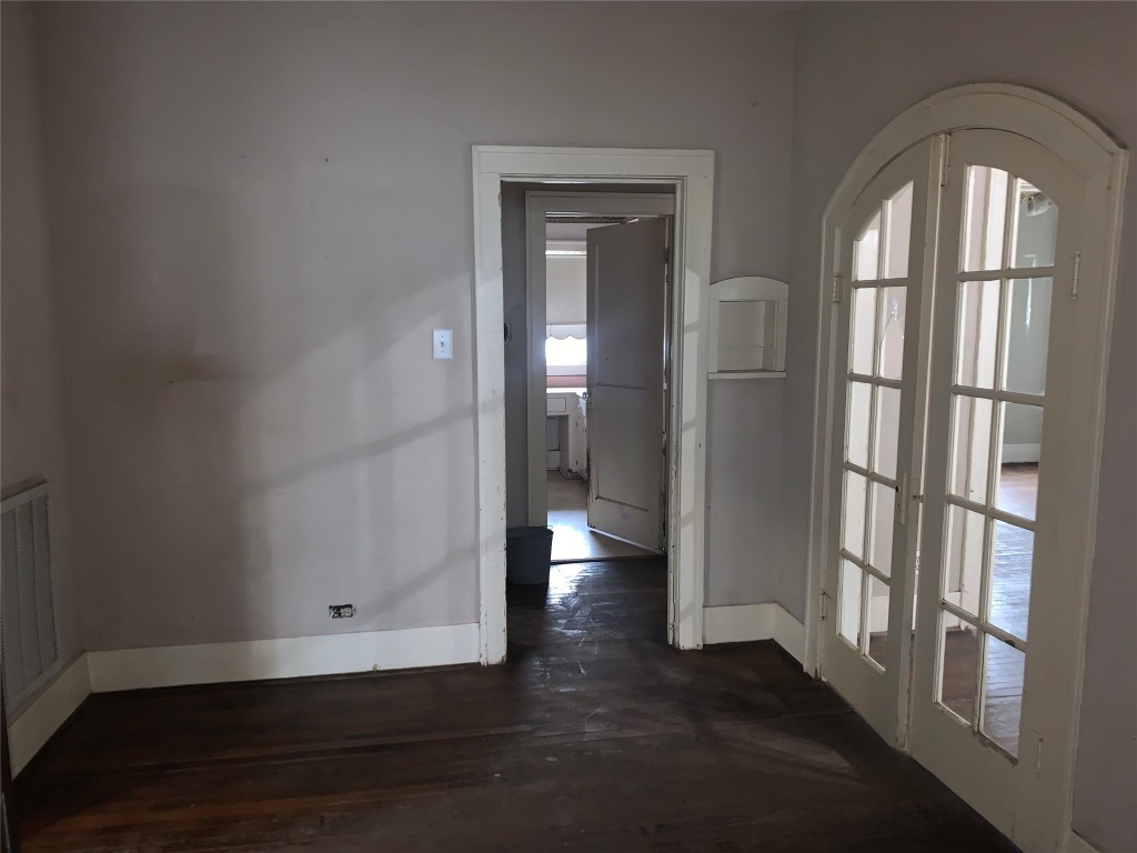 22720 Hudson Road New Caney, TX 77357 - Photo 14 of 40 an empty room with wooden floor and a window