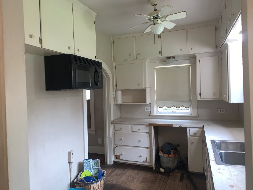 22720 Hudson Road New Caney, TX 77357 - Photo 19 of 40 a kitchen with a cabinets and a stove with wooden floor
