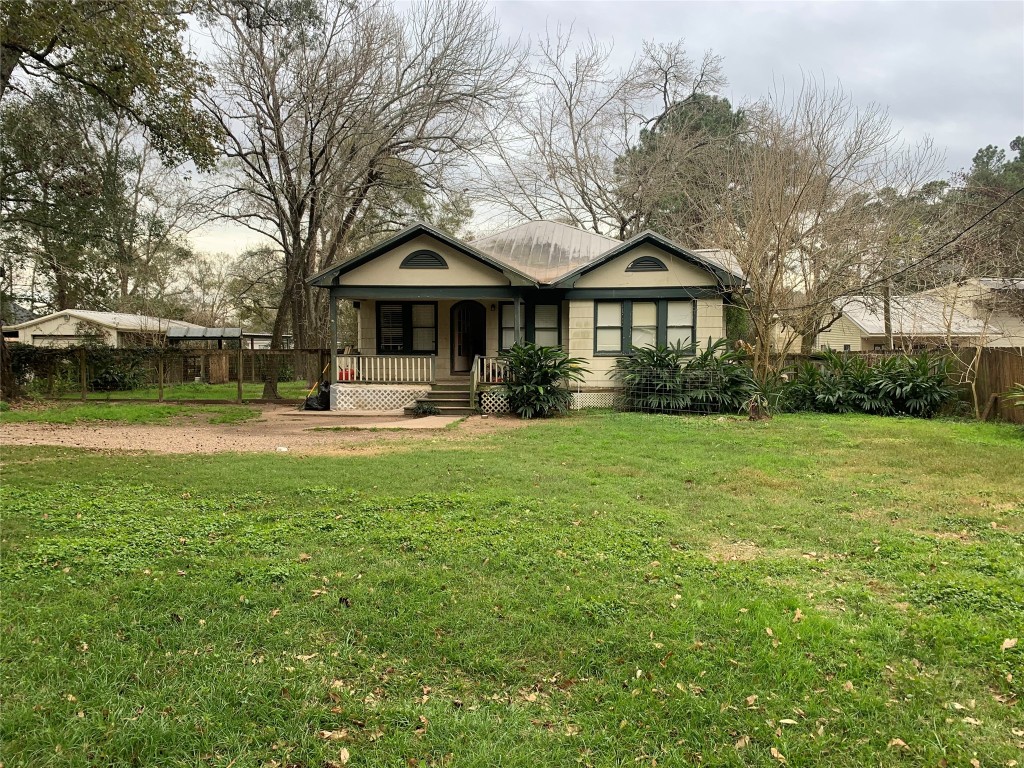 22720 Hudson Road New Caney, TX 77357 - Photo 2 of 40 a front view of a house with garden and trees