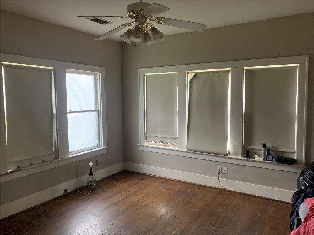 22720 Hudson Road New Caney, TX 77357 - Photo 32 of 40 an empty room with wooden floor fan and windows