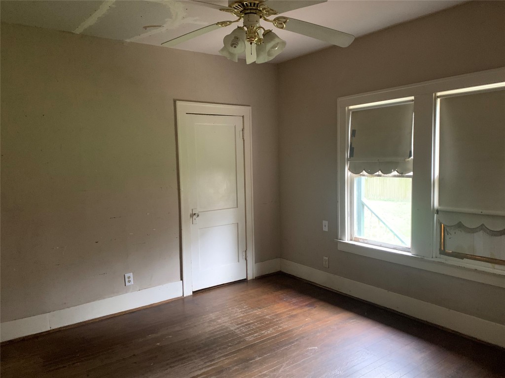22720 Hudson Road New Caney, TX 77357 - Photo 8 of 40 a view of an empty room with wooden floor and a window