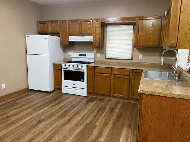 a kitchen with a sink a stove and refrigerator
