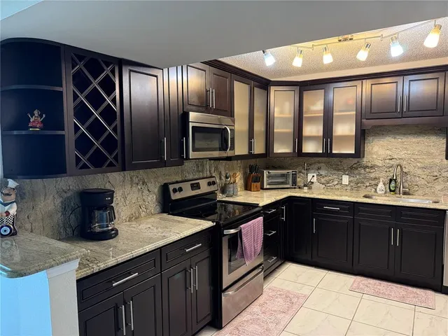 a kitchen with a refrigerator and cabinets