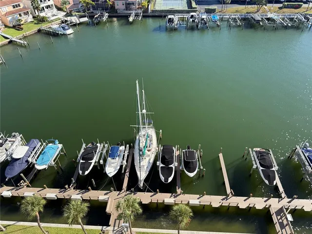a view of a swimming pool with outdoor seating and plants