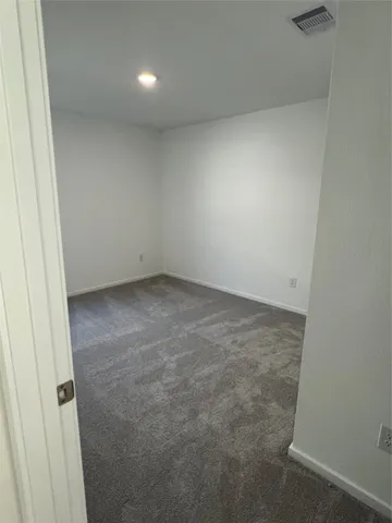 a view of an empty room and entryway