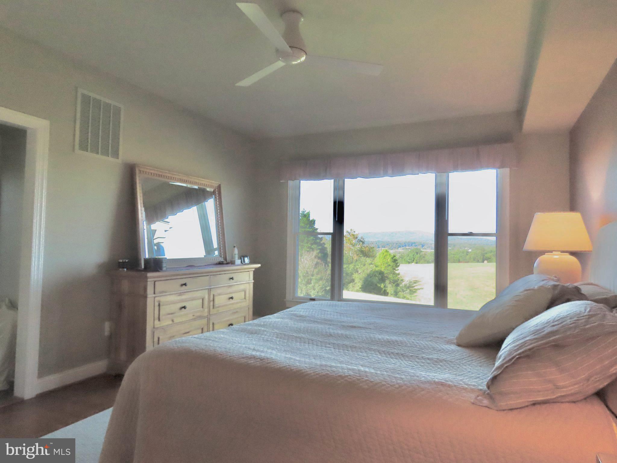 643 Richmond Road Amissville, VA 20106 - Photo 25 of 48 a bedroom with a large bed and a window