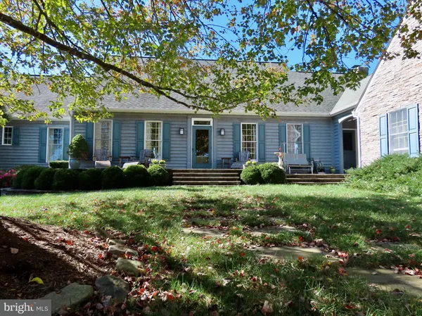a front view of house with yard and trees around