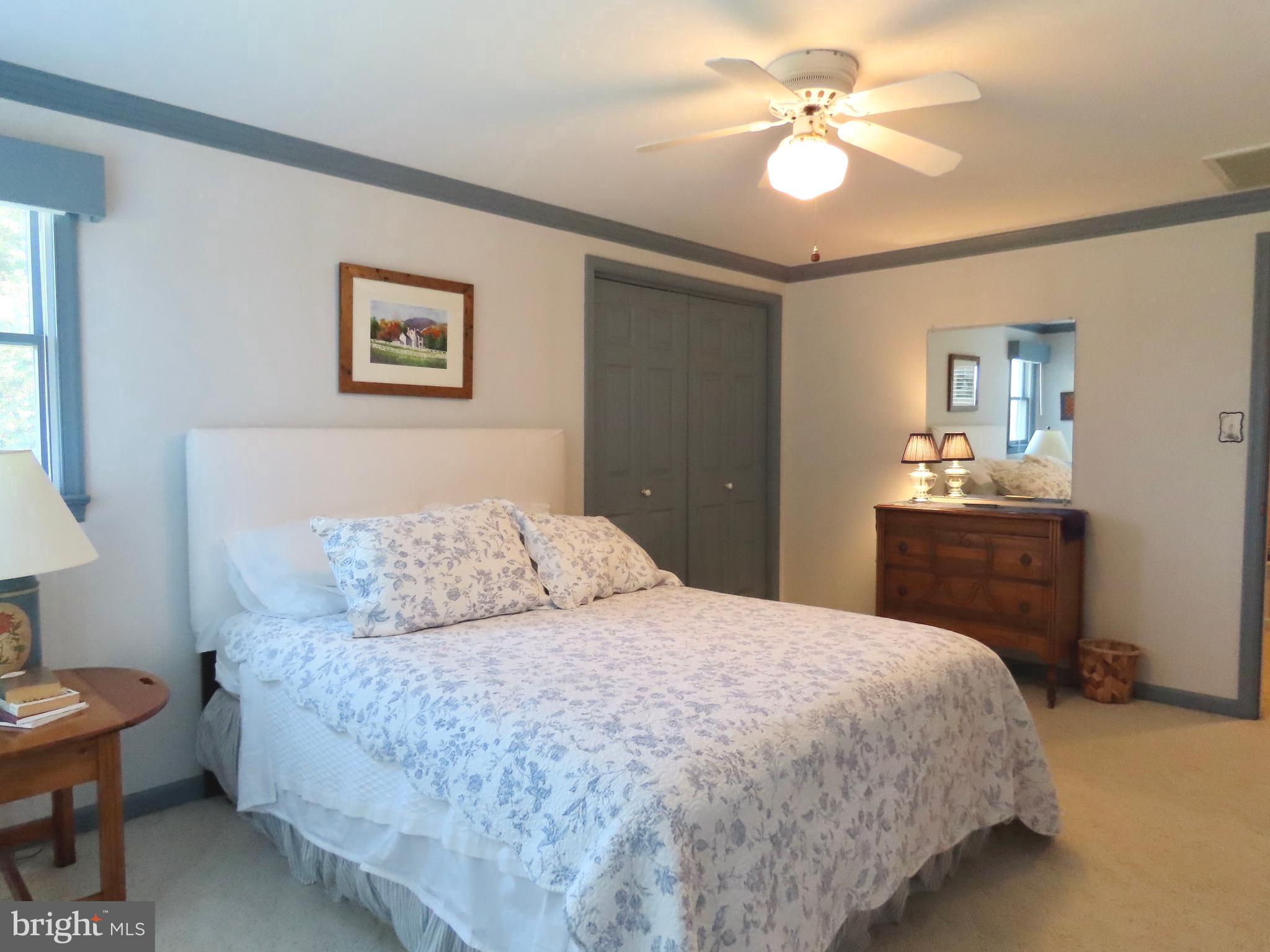 643 Richmond Road Amissville, VA 20106 - Photo 34 of 52 a bedroom with a bed and a chandelier