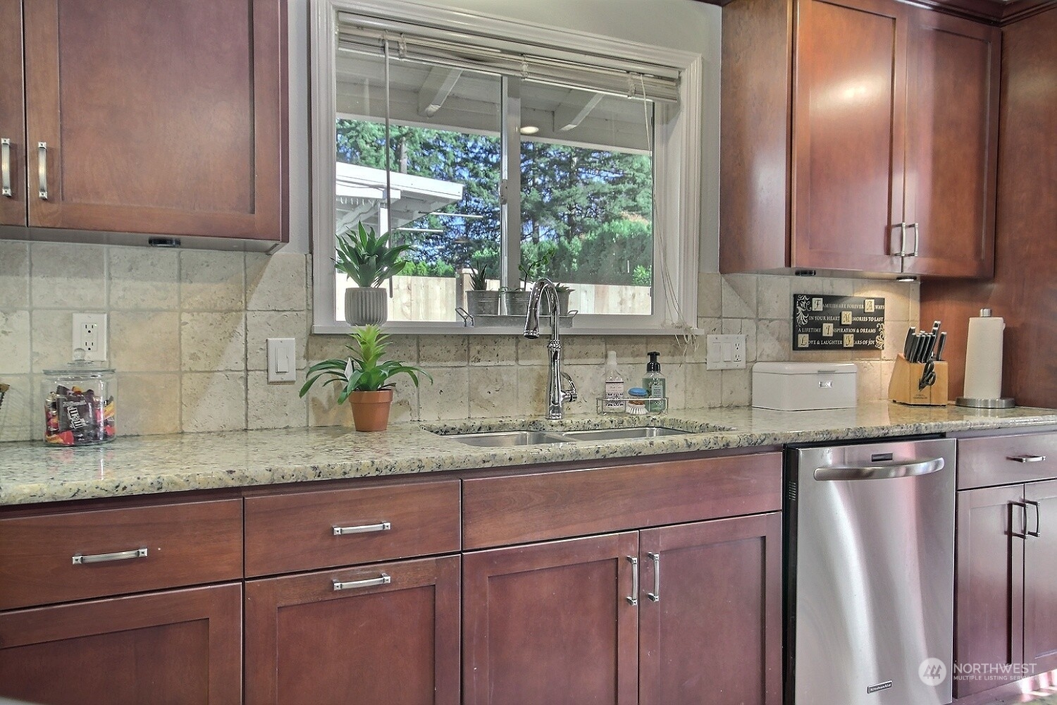 16613 Southeast 145th Street Renton, WA 98059 - Photo 17 of 40 a kitchen with granite countertop stainless steel appliances white cabinets and a window