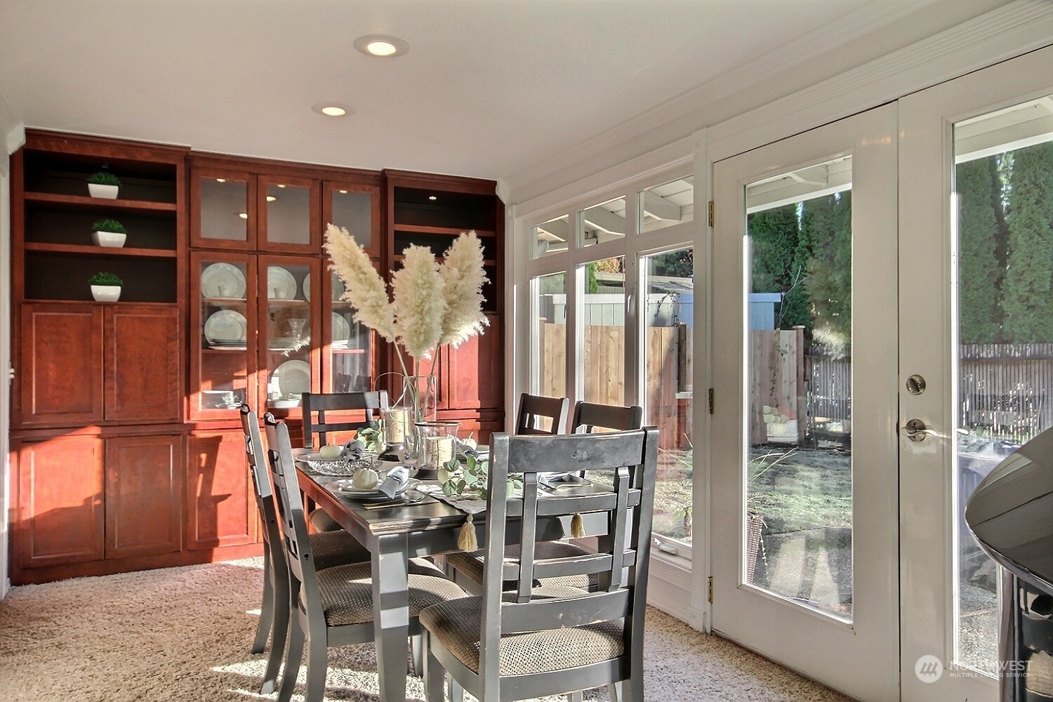 16613 Southeast 145th Street Renton, WA 98059 - Photo 22 of 40 a view of a dining room and livingroom with furniture wooden floor a chandelier