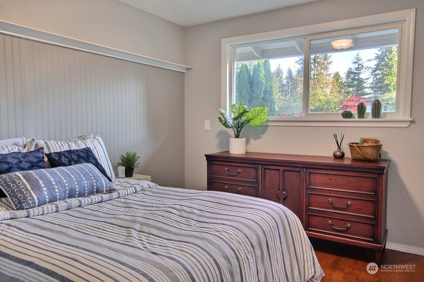 16613 Southeast 145th Street Renton, WA 98059 - Photo 26 of 40 a bedroom with a large bed and a potted plant