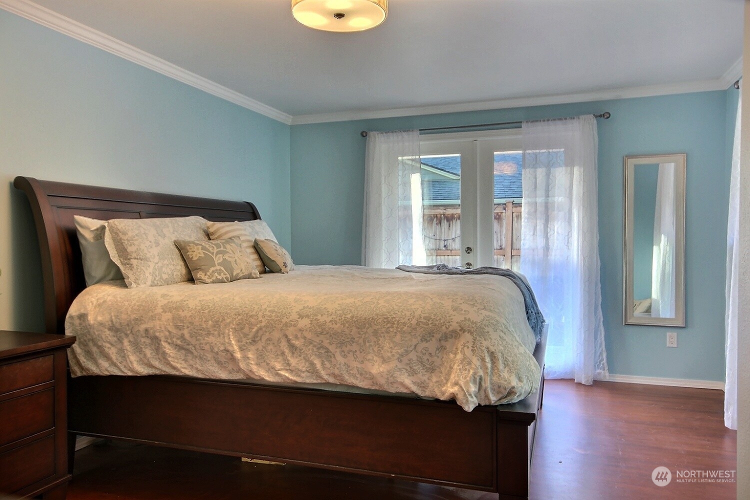 16613 Southeast 145th Street Renton, WA 98059 - Photo 31 of 40 a bed sitting in a bedroom next to a window and wooden floor