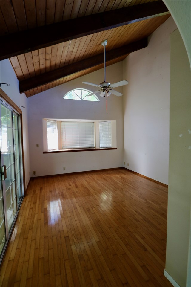 475 Kulike Road, Unit 2 Haiku, HI 96708 - Photo 19 of 26 an empty room with wooden floor and windows