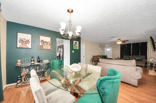 a view of a dining room with furniture and wooden floor