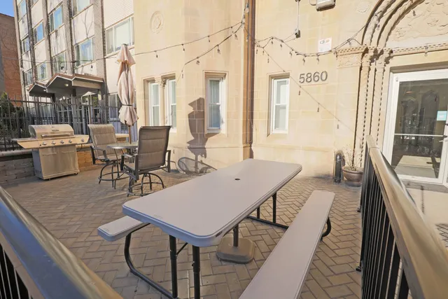 a view of a patio with table and chairs