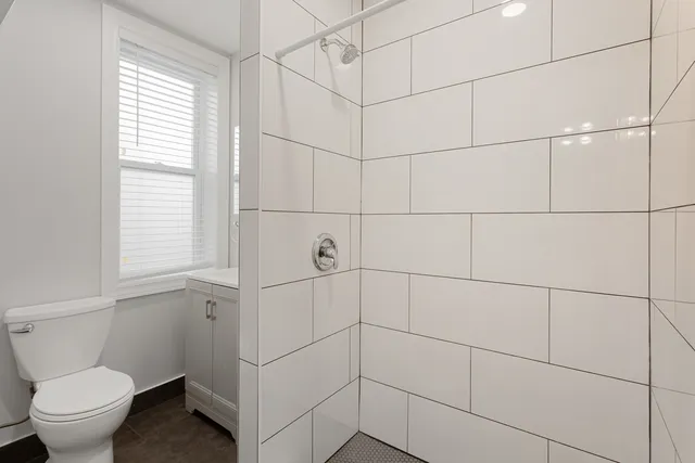 a bathroom with a toilet and a shower