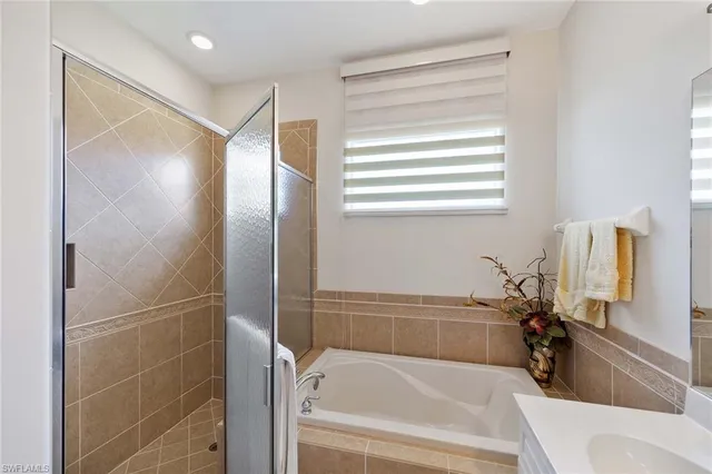 a bathroom with a bathtub and a shower