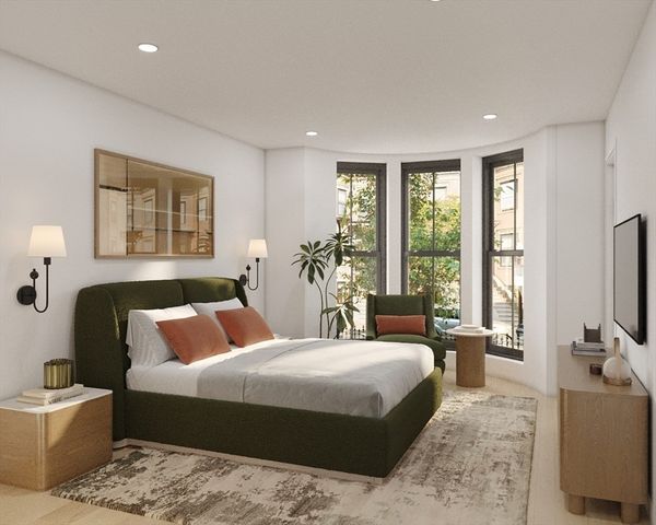 a bedroom with a large bed and a flat screen tv