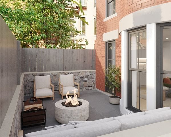 a backyard of a house with fire pit and outdoor seating